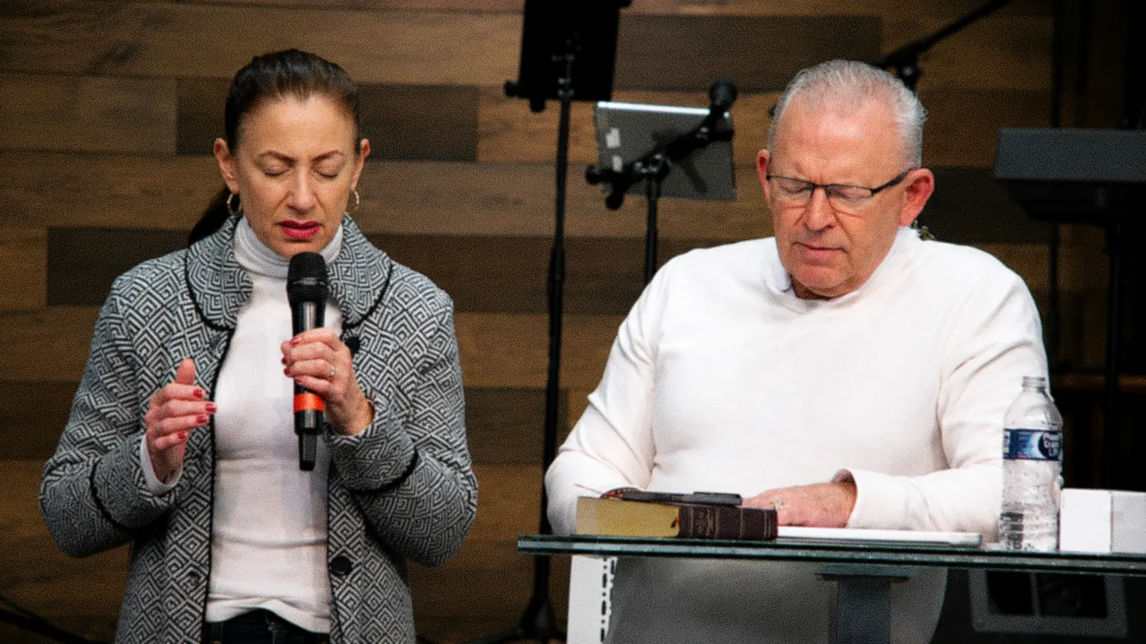 Dr. James and Michele Horvath praying together during a service at Calvary Lighthouse Church